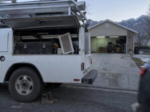 Work truck parked on a residential street in Magna Ut by Aegis Heating and Air