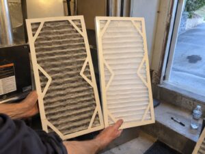 Comparing an old dirty filter to a new one by Aegis Heating and Air