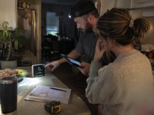 Reviewing an IAQ monitor with a homeowner in Dehumidifiers by Aegis Heating and Air