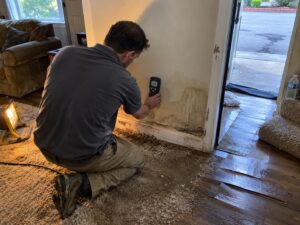 Moisture reading on damaged drywall in Meet The Team by Aegis Heating and Air