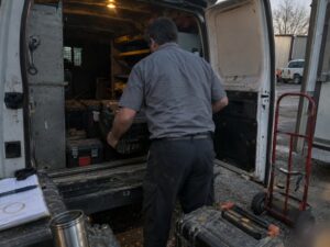 Loading assorted service equipment into a work truck in Maintenance by Aegis Heating and Air